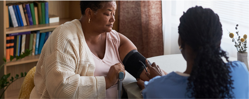 Image of woman taking her blood pressure sourced from Canva.com