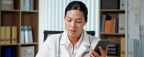 Image of phatmacists on a phone consultation and taking notes sourced from Canva.com